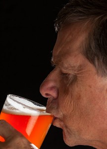 Senior man sipping beer
