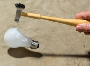 Hitting incandescent lightbulb with hammer