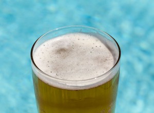 Glass of beer by pool