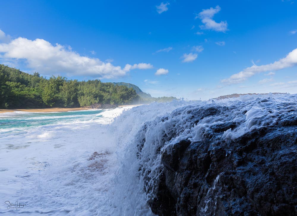 Massive waves crash over the rocks on Lumaha'i beach in Kauai